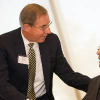 Richard DeVos shaking hands with President Emeritus Mark Murray.